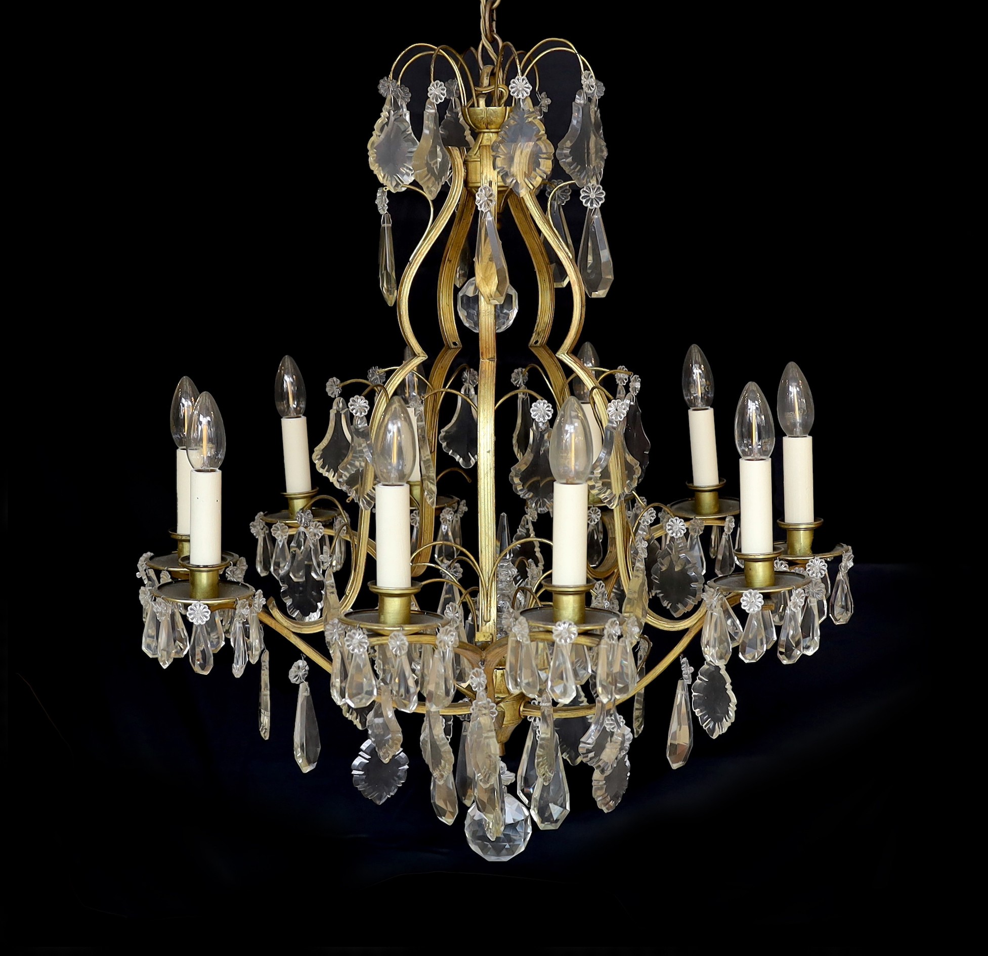 An early 20th century French silver and bronze and cut glass ten light chandelier hung with lozenge and tear shaped drops, drop 82cm. width 60cm